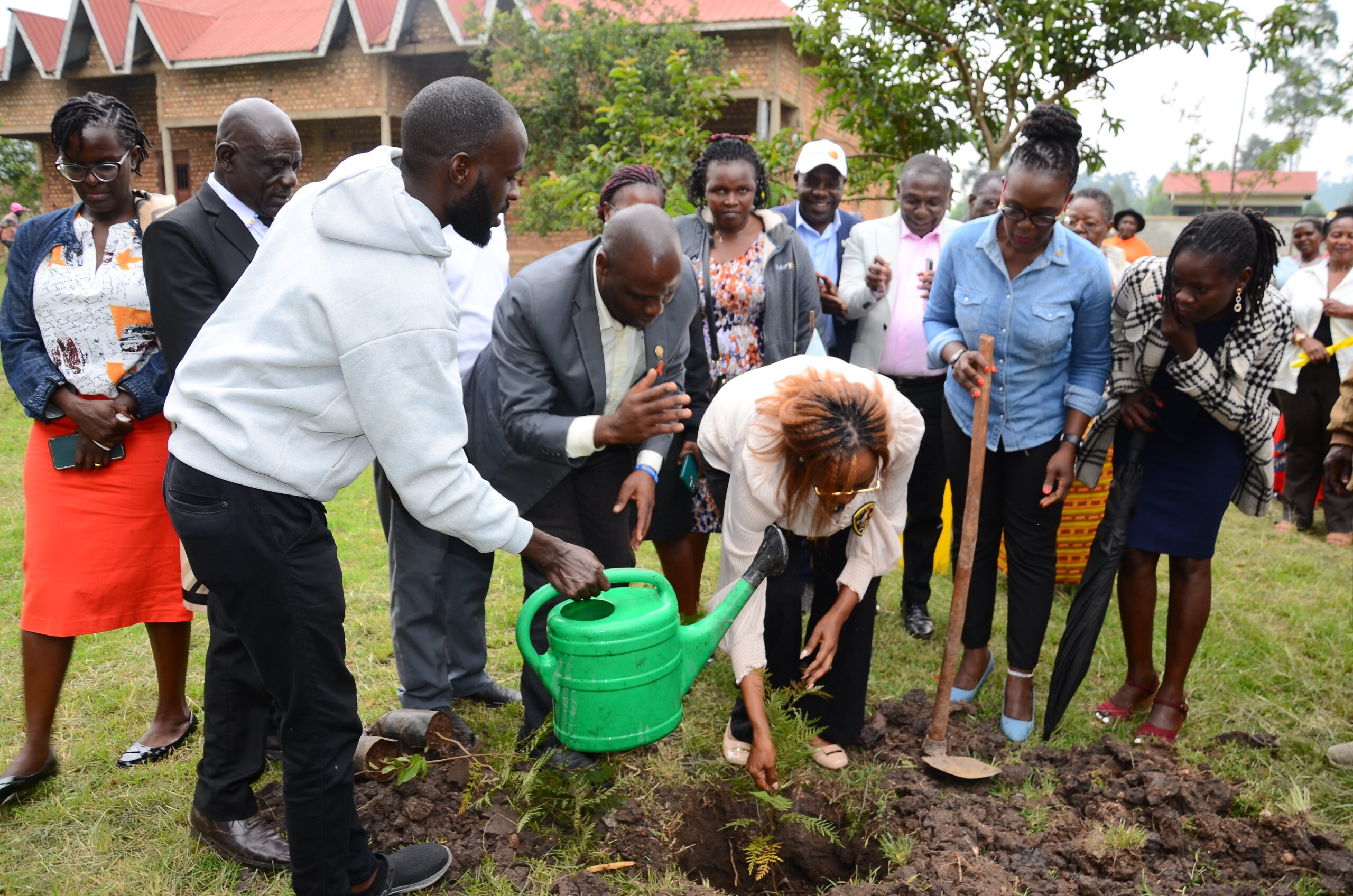 Rotary Club of Lake Bunyonyi members planting trees along the shores of Lake Bunyonyi to promote environmental sustainability in Kabale, Uganda